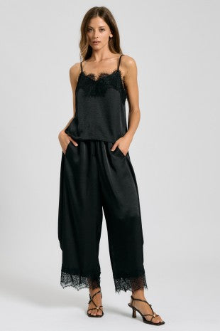 Black satin two-piece set with lace-trim camisole and cropped wide-leg pants